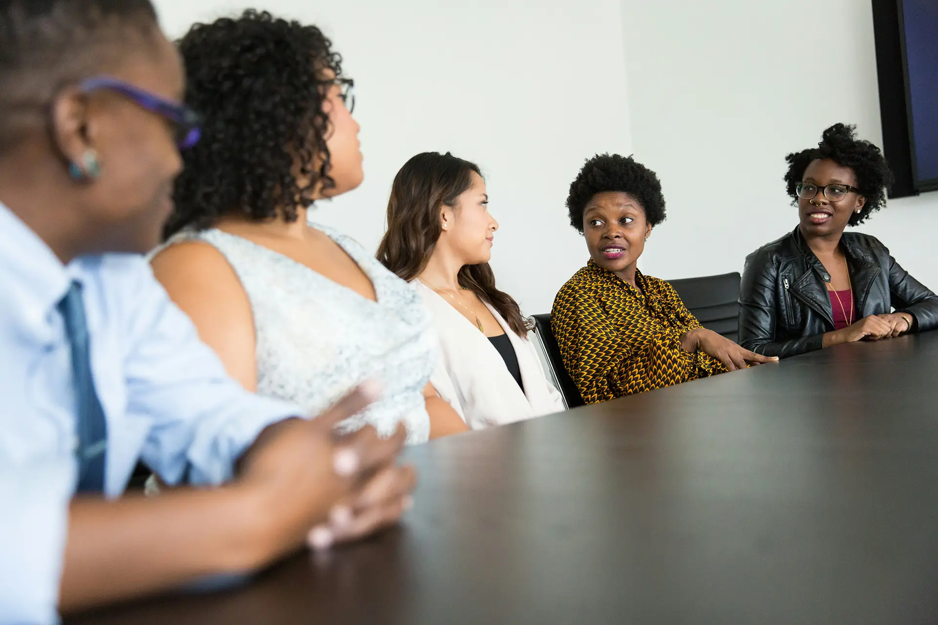 A group of professionals having a discussion at a desk.